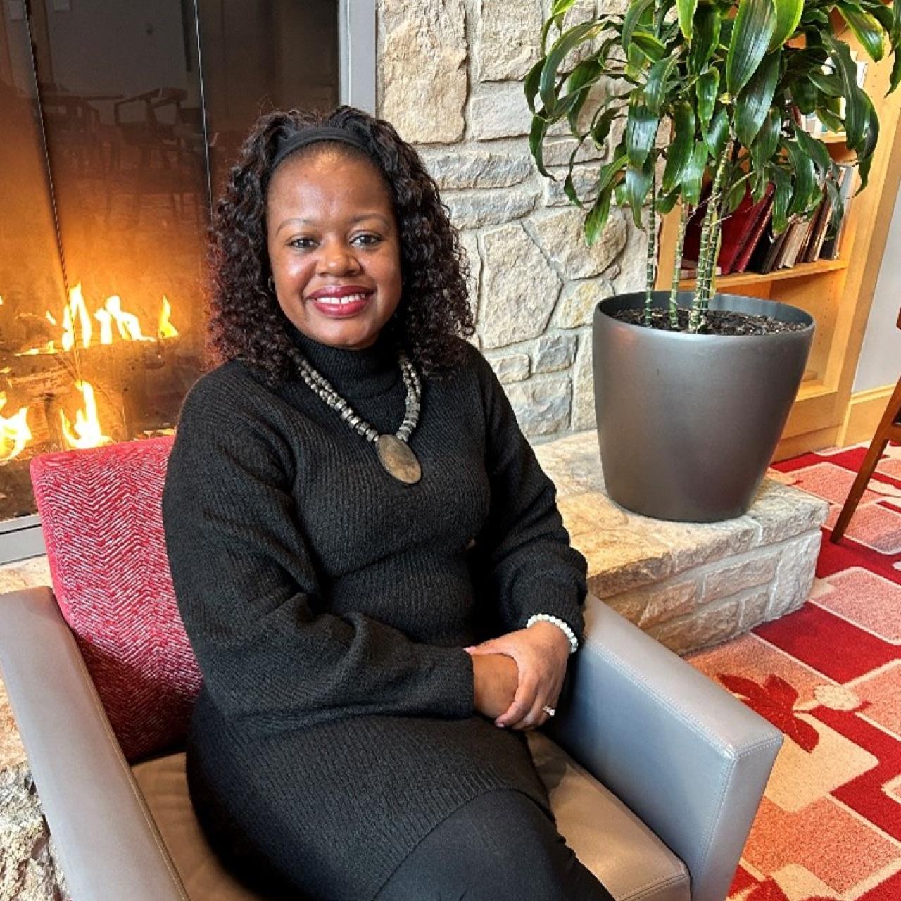 woman sitting by the fireplace