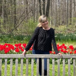 woman standing in front of flowers