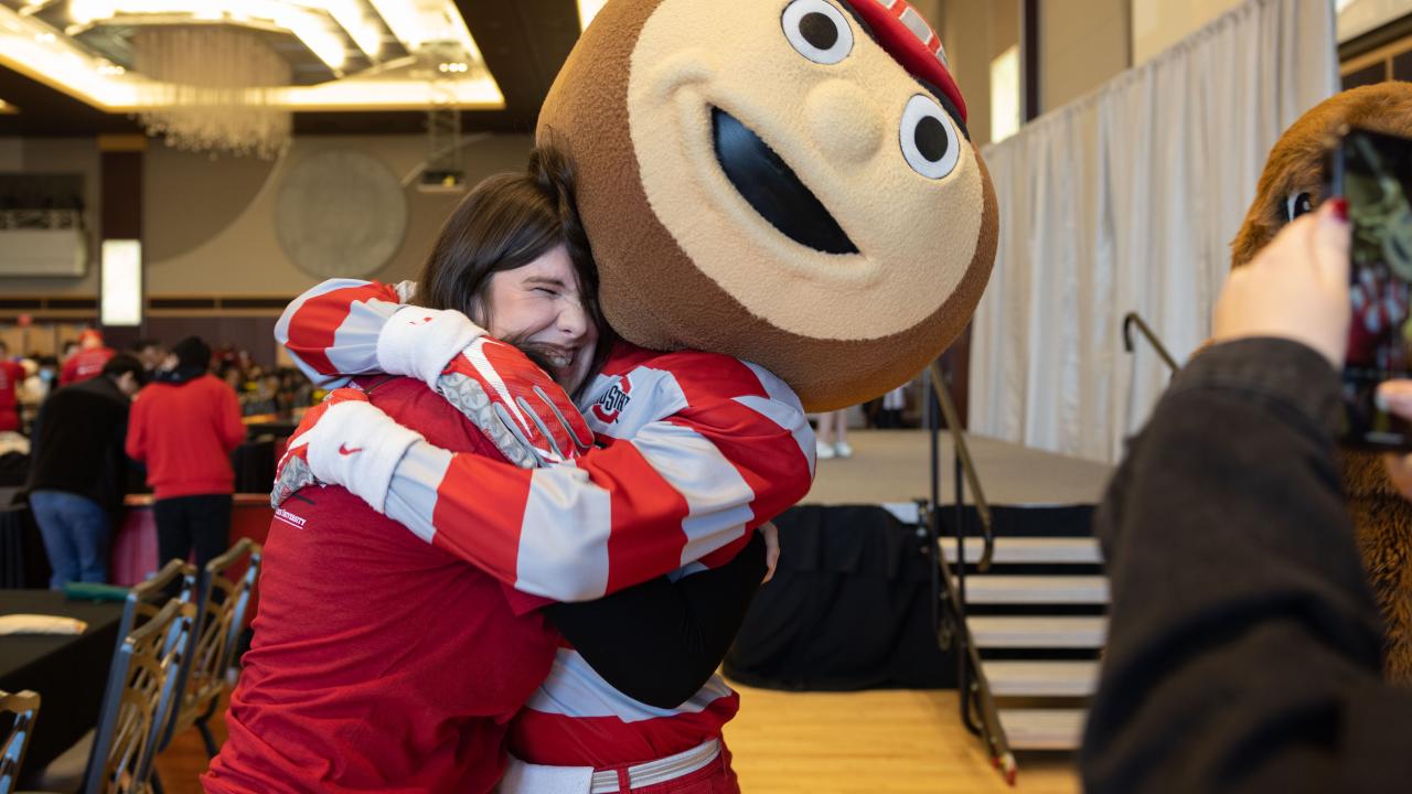 Mascot hugging a woman